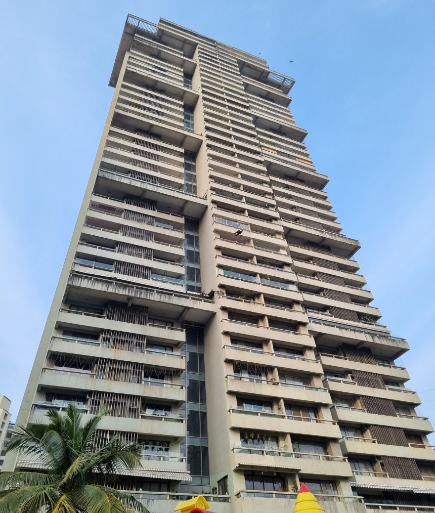 High-rise tower under repair with scaffolding and site engineers